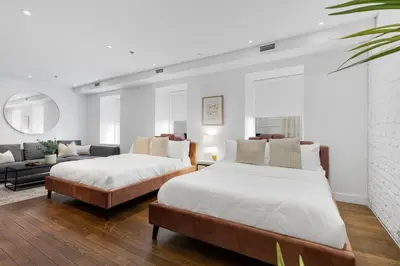two beds in a living room with a couch at The SFX Old Port in Montréal