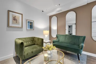 a living room with two green chairs and a table at The SFX Old Port in Montréal