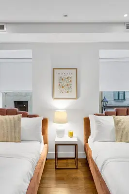 two beds in a living room with a table at The SFX Old Port in Montréal