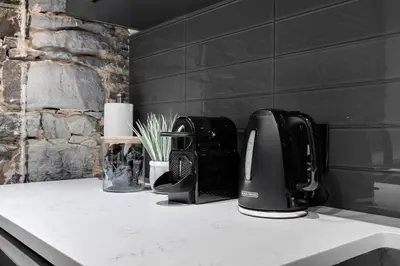 a kitchen counter with a coffee maker on a counter top at The SFX Old Port in Montréal