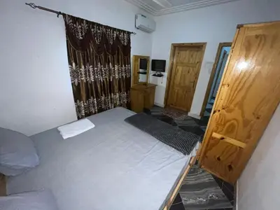 a small bedroom with a bed and a window at Cozy Home in Montréal
