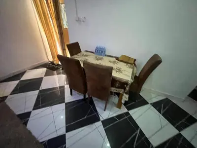 a dining room table with chairs and a checkered floor at Cozy Home in Montréal