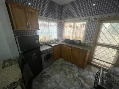 a small kitchen with a sink and a washer and dryer at Cozy Home in Montréal