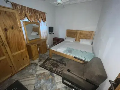 a small bedroom with a bed and a mirror at Cozy Home in Montréal