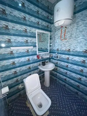 a bathroom with a toilet and a sink at Cozy Home in Montréal