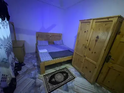 a small room with a bed and a cabinet at Big Home in Montréal