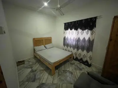 a small room with a bed and a curtain at Big Home in Montréal