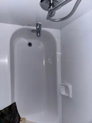 a white tub in a bathroom with a ceiling at Chambre a louer in Montréal
