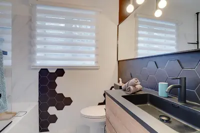 a bathroom with a sink and a toilet at CHALET Le HAVRE NATURE SPA in Mansonville