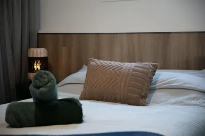 a bed with a stuffed animal sitting on top of it at CHALET Le HAVRE NATURE SPA in Mansonville