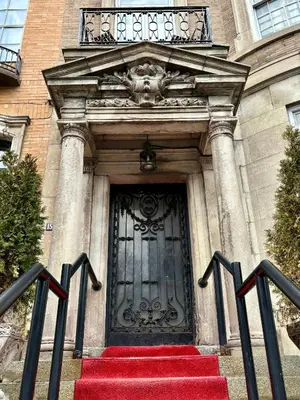a door to a building with a red staircase at Authentic Spacious 1BDR In Downtown Montreal in Montréal