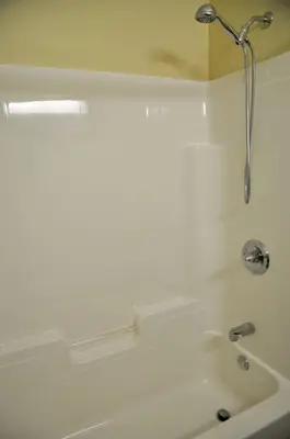 a bathroom with a shower and a bath tub at Motel des Cèdres in Sherbrooke