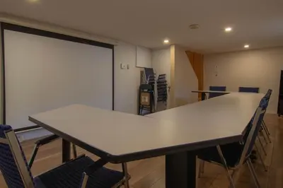 a meeting room with a table and chairs in it at Cozy Bungalow Longueuil - 3 BR - 6 pers in Longueuil