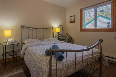 a bedroom with a bed with a hat on it at Cozy Bungalow Longueuil - 3 BR - 6 pers in Longueuil