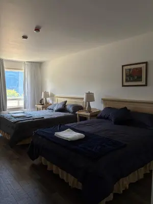 a hotel room with two beds and a window at Motel Le Villageois Du Lac in Saint-Francois-du-Lac