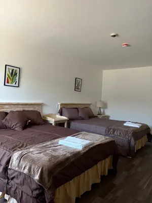 a room with two beds in a room at Motel Le Villageois Du Lac in Saint-Francois-du-Lac