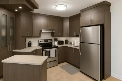 a kitchen with wooden cabinets and a stainless steel refrigerator at Golden Mile Luxe Apartment in Montréal