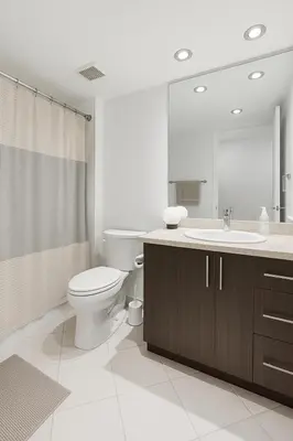 a bathroom with a toilet and a sink at Golden Mile Luxe Apartment in Montréal