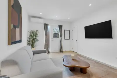 a living room with a couch and a coffee table at Le Victoria Midtown Mtl in Montréal
