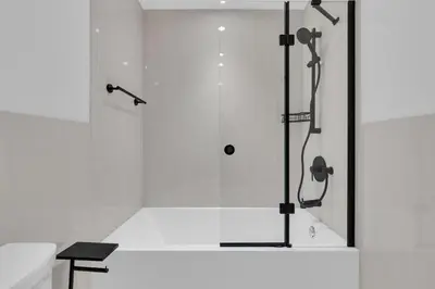 a bathroom with a shower with a glass door at Le Victoria Midtown Mtl in Montréal