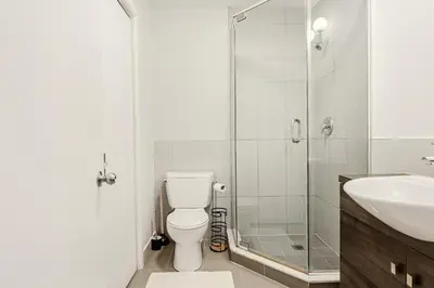 a bathroom with a toilet and a glass shower at Escapade Chic au Vieux-Port in Montréal