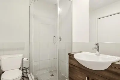 a bathroom with a toilet and a sink and a shower at Escapade Chic au Vieux-Port in Montréal