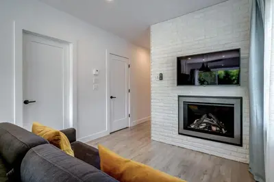 a living room with a couch and a fireplace at 851 condo in Bromont Vieux Village mountain view in Bromont