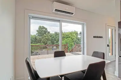 a dining room with a white table and chairs at 853 condo in Bromont Vieux Village mountain view in Bromont