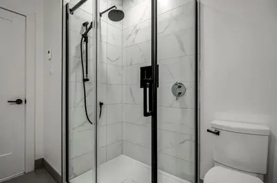a bathroom with a glass shower with a toilet at 853 condo in Bromont Vieux Village mountain view in Bromont