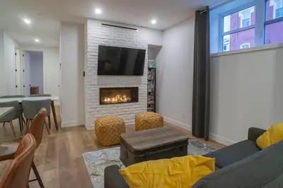a living room with a couch and a fireplace at Most beautiful condo 101 in Bromont Vieux in Bromont