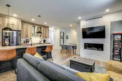 a living room with a couch and a fireplace at Most beautiful condo 101 in Bromont Vieux in Bromont
