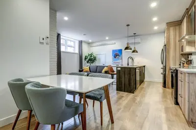 a kitchen and living room with a table and chairs at Most beautiful condo 101 in Bromont Vieux in Bromont
