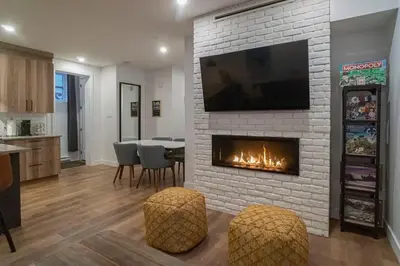 a living room with a fireplace with a tv above it at Most beautiful condo 101 in Bromont Vieux in Bromont