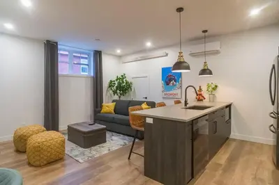 a kitchen and living room with a couch and a table at Most beautiful condo 101 in Bromont Vieux in Bromont