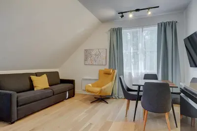 a living room with a couch and a table at Loft at 913 Shefford in Bromont
