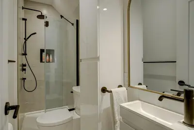 a bathroom with a shower and a toilet and a sink at Loft at 913 Shefford in Bromont