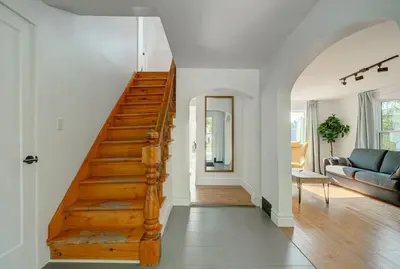 a staircase in a living room with a couch at 891 shefford 4-bedroom house in Bromont