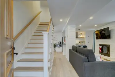 a living room with a couch and a staircase at 951 Shefford 4 bedrooms house in Bromont
