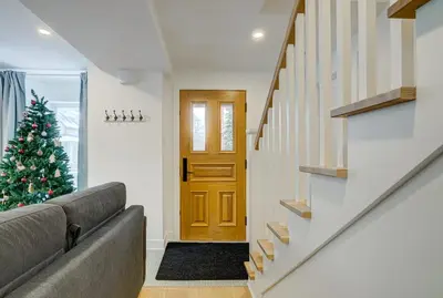 a living room with a christmas tree and a door at 951 Shefford 4 bedrooms house in Bromont