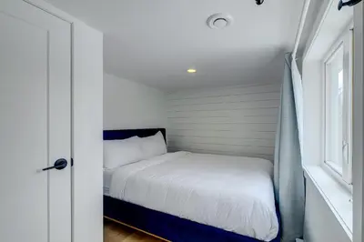 a bed in a small room with a window at 951A Shefford Bromont 3 bedrooms in Bromont