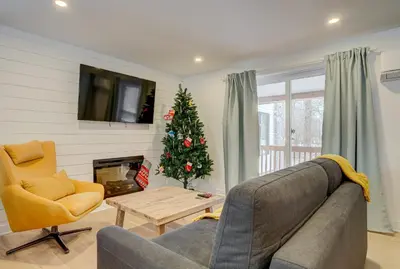 a living room with a couch and a christmas tree at 951A Shefford Bromont 3 bedrooms in Bromont