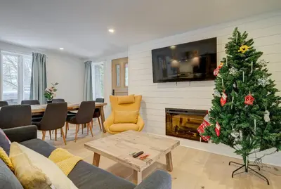 a living room with a christmas tree and a fireplace at 951A Shefford Bromont 3 bedrooms in Bromont
