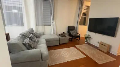a living room with a couch and a flat screen tv at Spacious Condo with a Bright Interior in Montréal
