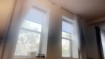 a window with white curtains in a room at Spacious Condo with a Bright Interior in Montréal