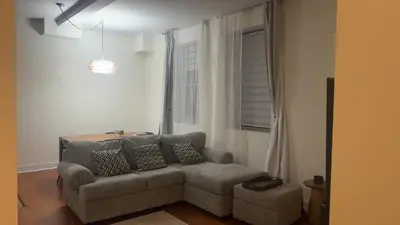 a living room with a couch and a window at Spacious Condo with a Bright Interior in Montréal