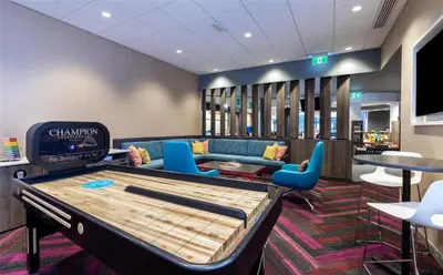 a room with a pool table and chairs at Tru By Hilton Montréal centre-ville in Montréal