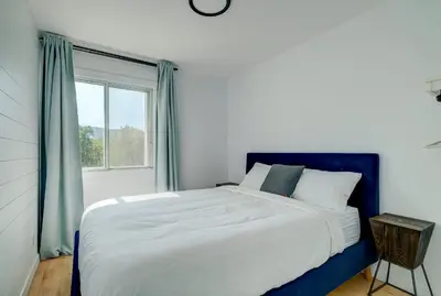 a bedroom with a large bed and a window at room with private bathroom 837 shefford suite 105 in Bromont