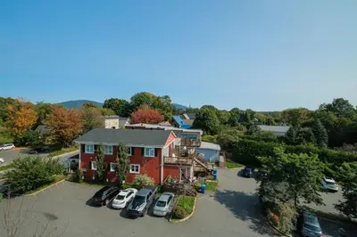 an aerial view of a house with cars parked in a parking lot at room with private bathroom 837 shefford suite 105 in Bromont