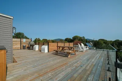 a deck with a picnic table and chairs on a roof at room with private bathroom 837 shefford suite 105 in Bromont