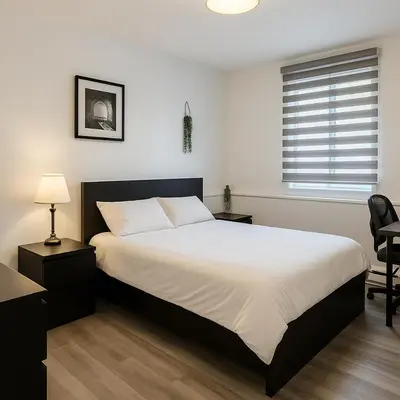 a bedroom with a large bed and a window at Grand Appartement 4 Chambres Rénové et Meublé in Montréal